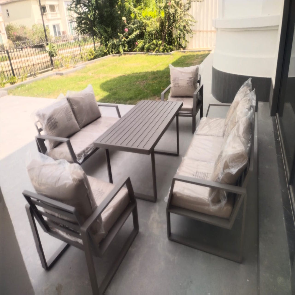 Outdoor patio furniture set with tables and chairs on a patio.